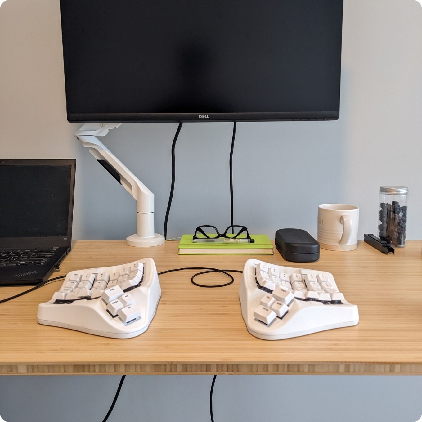 White Colored Concave Split Ergonomic TAIKO 01 Keyboard on a Desk with Monitor and Laptop in the back